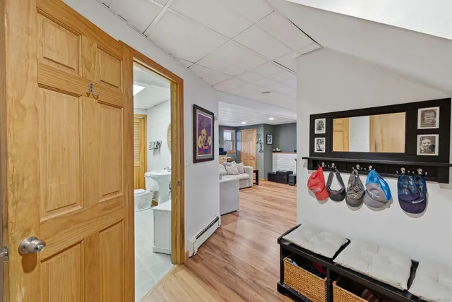 a view of a dining room with furniture a chandelier and wooden floor