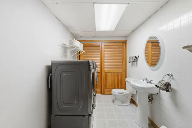 a bathroom with a toilet mirror and tub