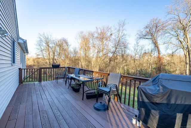 a view of a deck with wooden floor and outdoor seating
