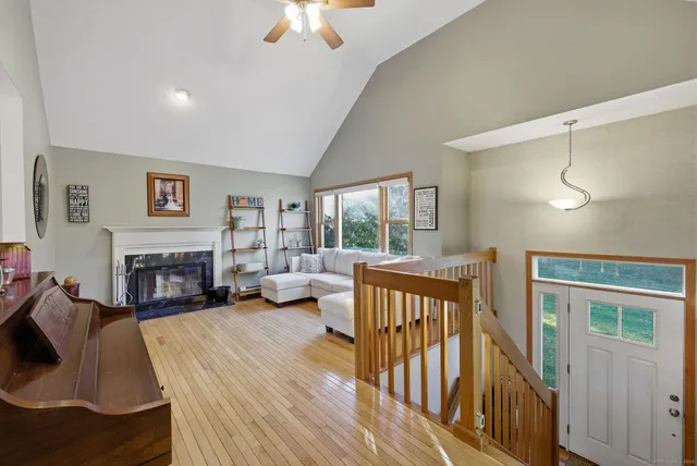 a view of a livingroom with furniture fire place and windows