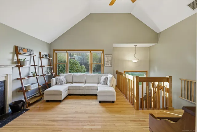 a living room with furniture and a floor to ceiling window