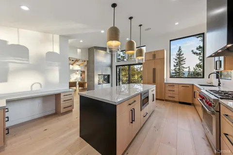 a kitchen with stainless steel appliances granite countertop a stove and a sink