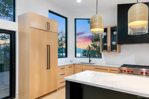 a kitchen with a sink a faucet a refrigerator and a stove