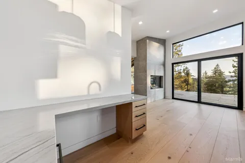a view of an empty room with window wooden floor and cabinet