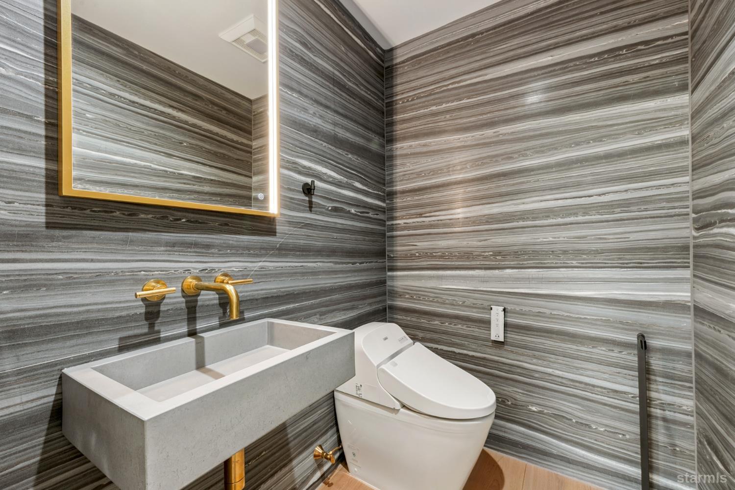 3960 Saddle Road South Lake Tahoe, CA 96150 - Photo 23 of 40 a bathroom with a toilet a sink and mirror