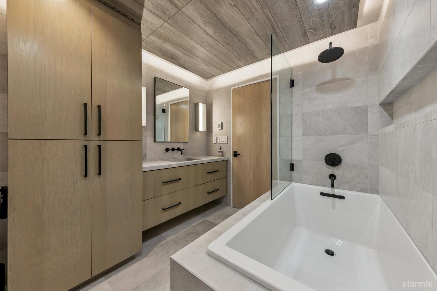 3960 Saddle Road South Lake Tahoe, CA 96150 - Photo 31 of 40 a bathroom with a tub sink a mirror and shower