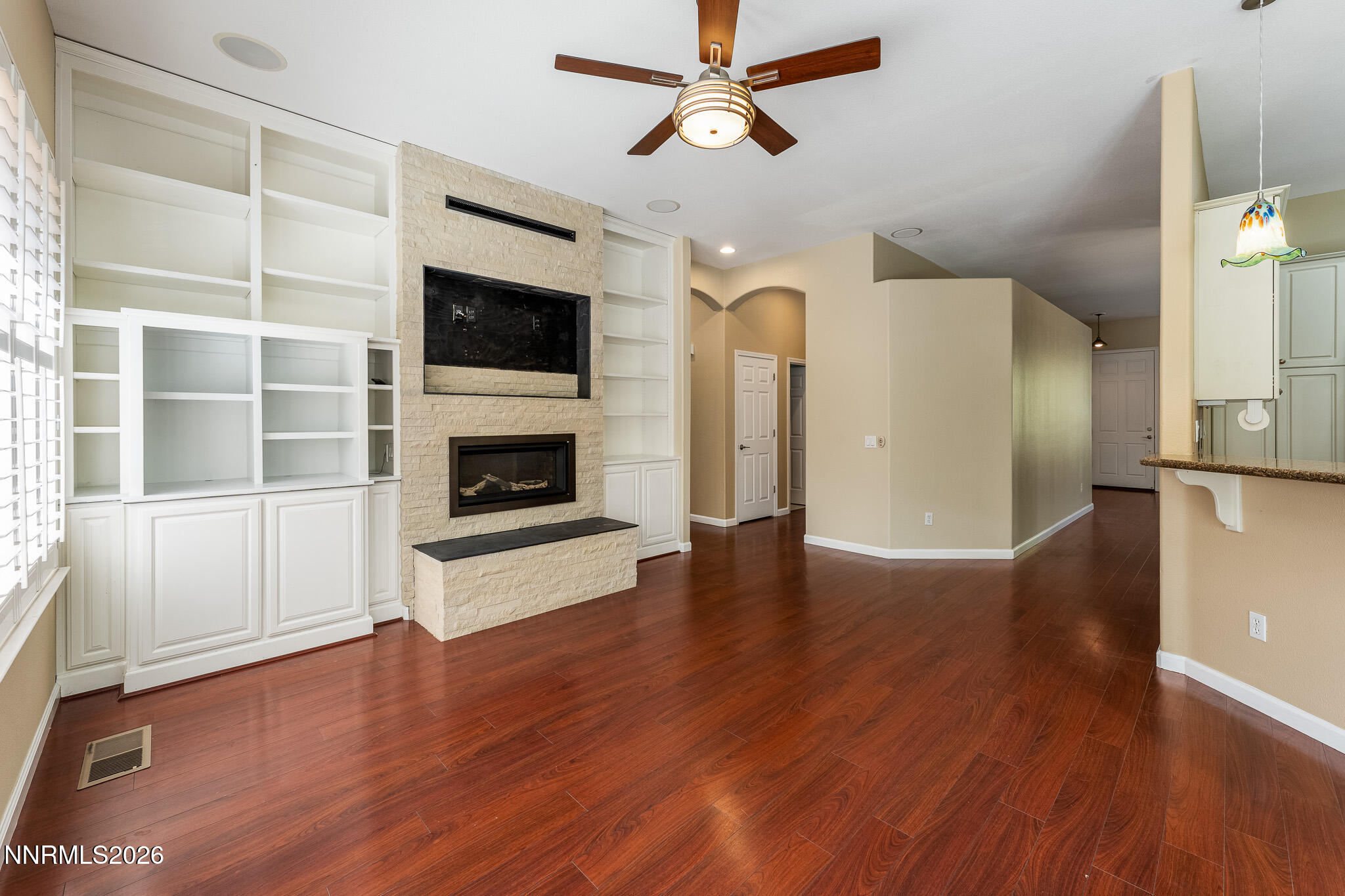 1840 Hunter Creek Road Reno, NV 89519 - Photo 4 of 39 a view of a livingroom with wooden floor and a ceiling fan