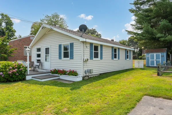 a front view of house with yard and outdoor seating