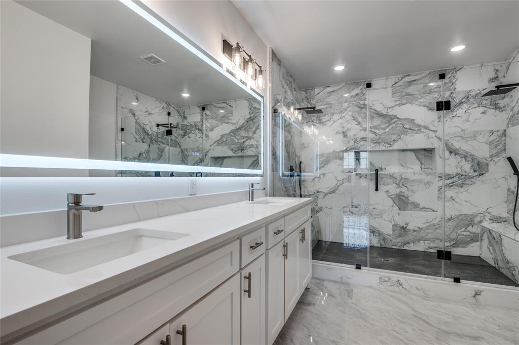 301 South Stewart Avenue Lancaster, TX 75146 - Photo 17 of 35 a spacious bathroom with a sink a large mirror and shower