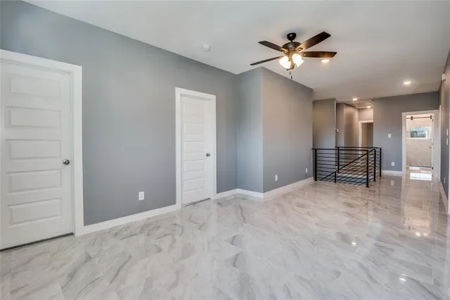 a view of a livingroom with a ceiling fan and wooden floor