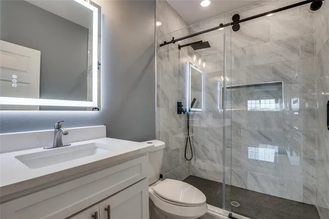 wooden floor in an empty room with a bathroom