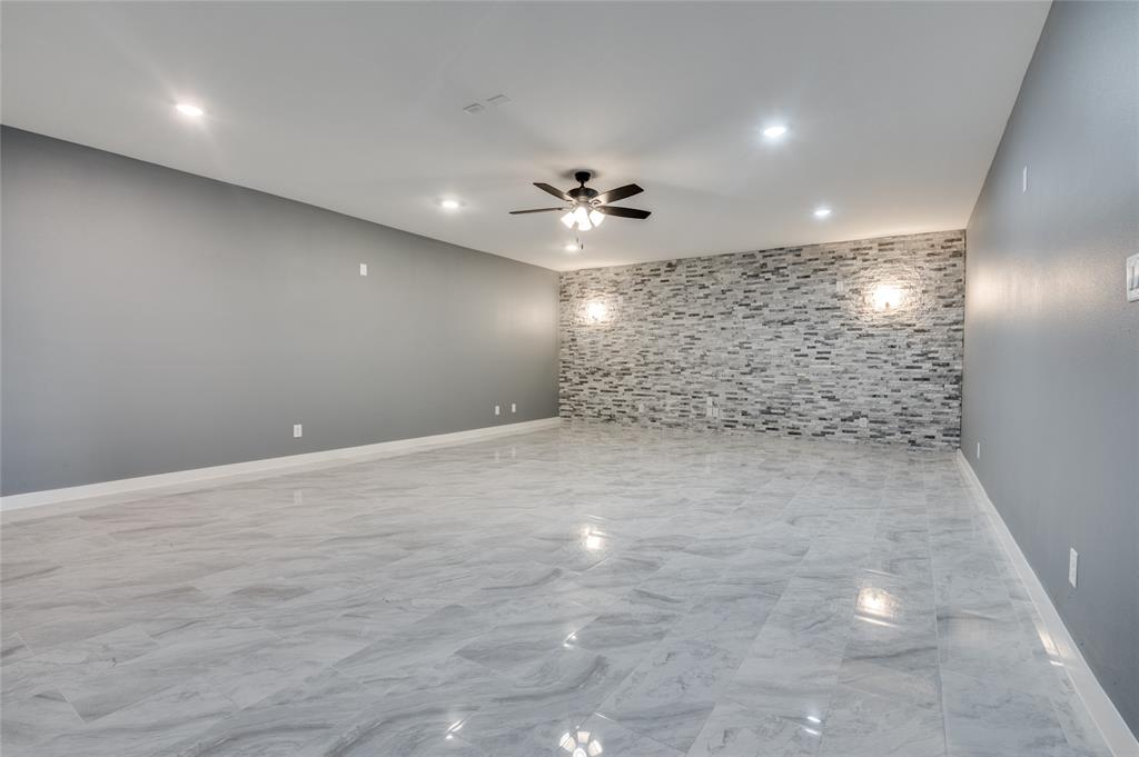 301 South Stewart Avenue Lancaster, TX 75146 - Photo 28 of 35 wooden floor in an empty room with a bathroom