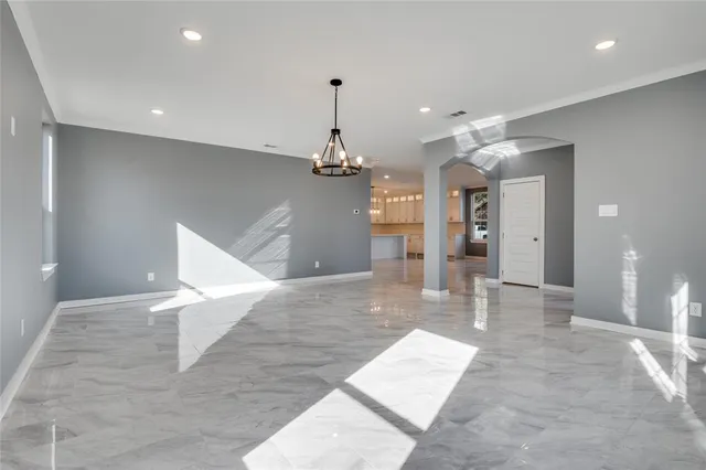 a view of kitchen with kitchen island white cabinets and refrigerator