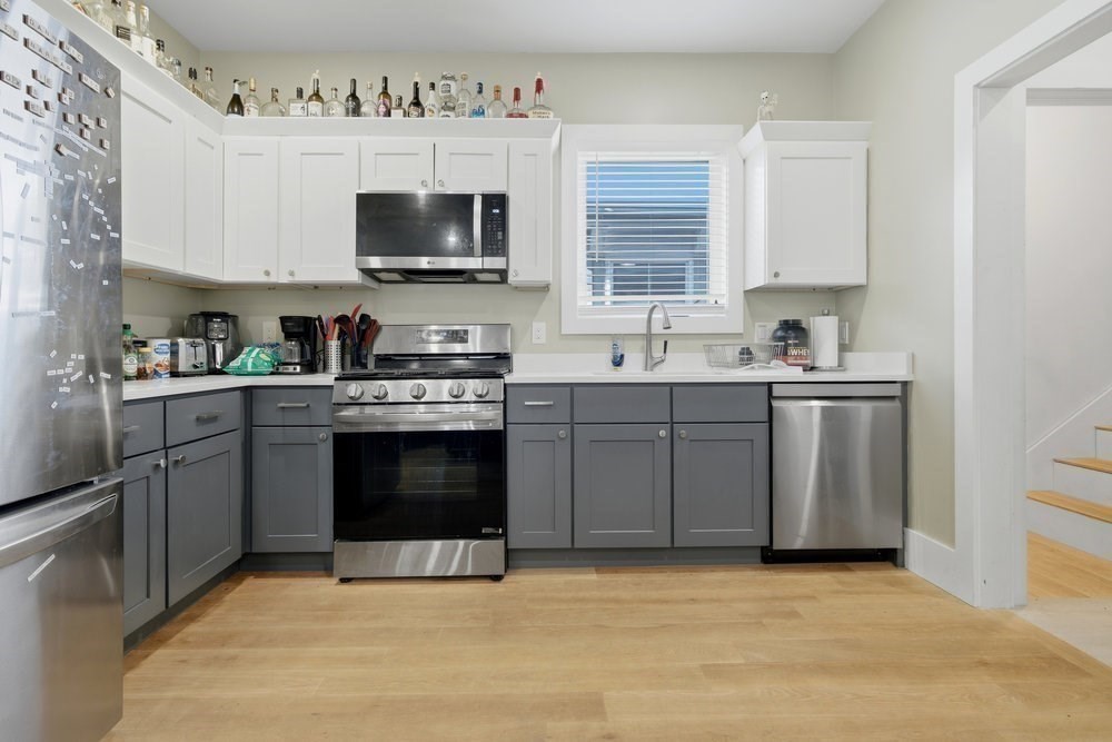 97 Hillside Street Boston, MA 02120 - Photo 15 of 41 a kitchen with stainless steel appliances a sink stove and microwave