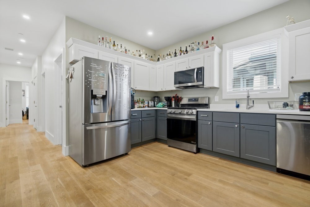 97 Hillside Street Boston, MA 02120 - Photo 16 of 41 a kitchen with stainless steel appliances granite countertop a refrigerator sink and stove