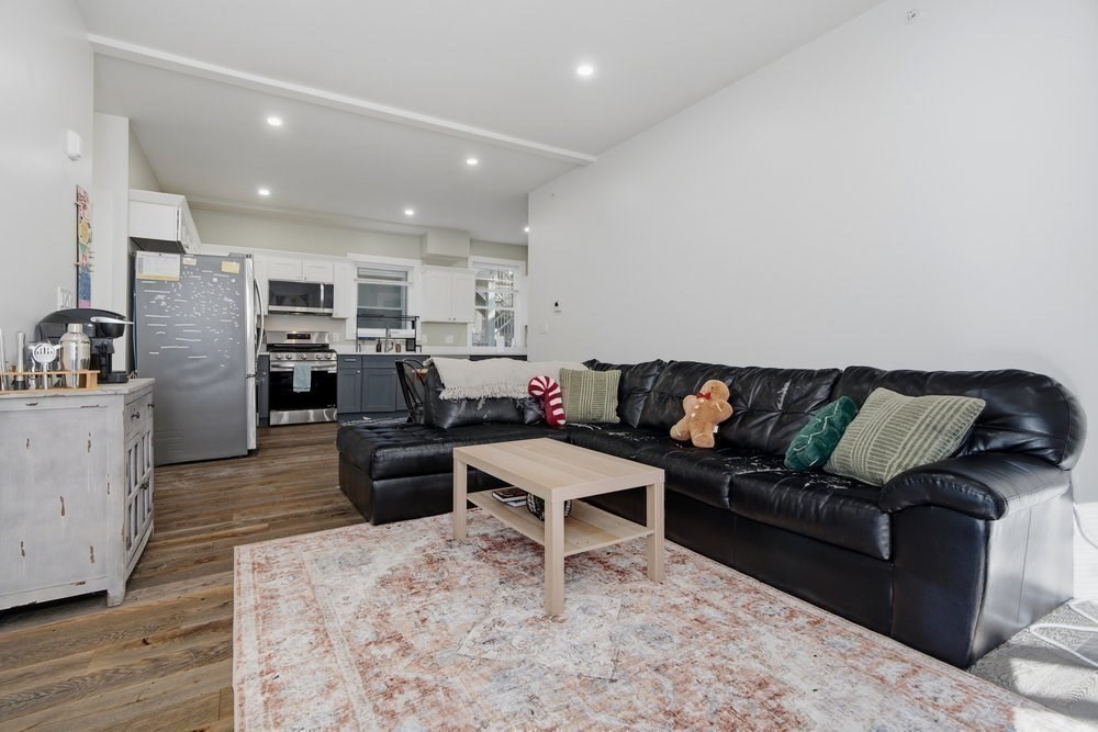 97 Hillside Street Boston, MA 02120 - Photo 17 of 41 a living room with furniture kitchen view and a refrigerator