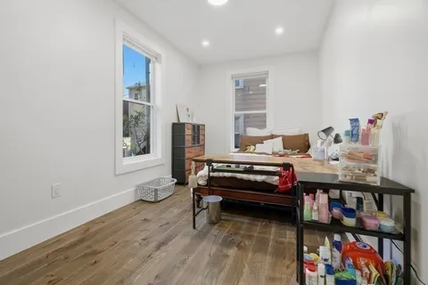 a bedroom with furniture and a book shelf