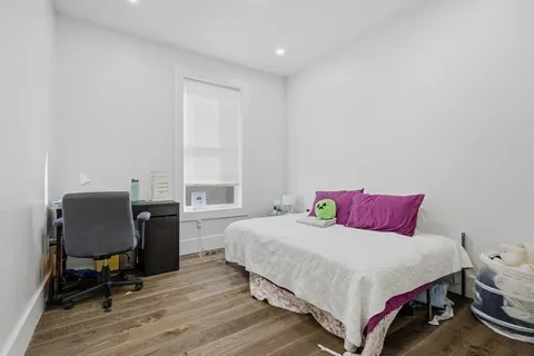 a bedroom with a bed and a desk