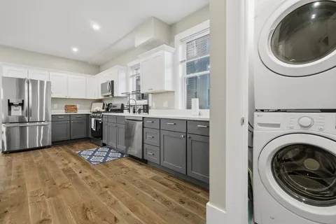 a kitchen with a sink a washer and dryer