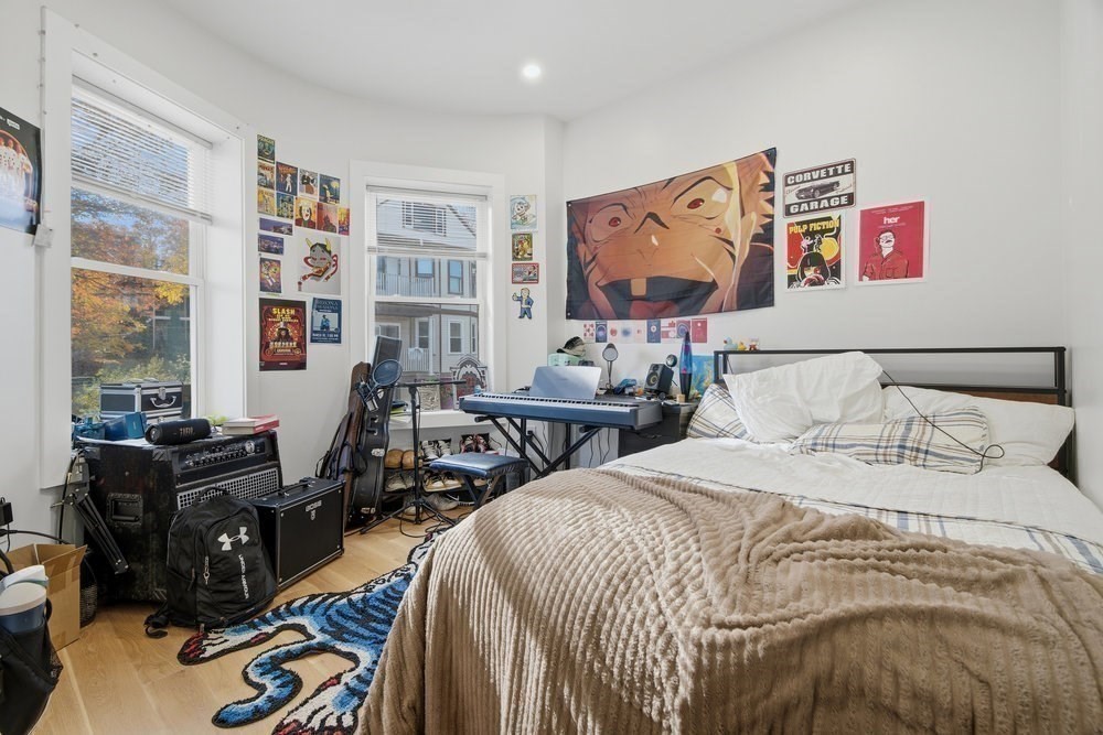 97 Hillside Street Boston, MA 02120 - Photo 29 of 41 a bedroom with a bed and wooden floor