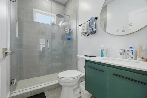 a bathroom with a sink a toilet and shower