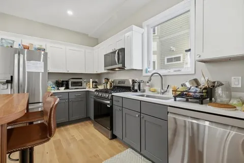 a kitchen with a sink cabinets and stainless steel appliances