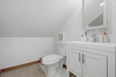 a bathroom with a sink a toilet and a mirror