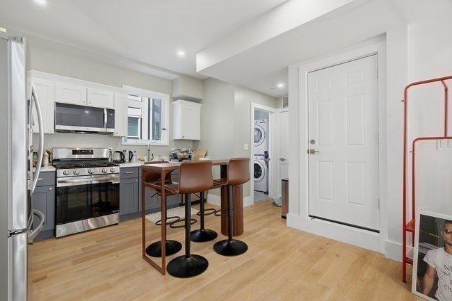 97 Hillside Street Boston, MA 02120 - Photo 4 of 41 a kitchen with stainless steel appliances kitchen island granite countertop a sink and a refrigerator