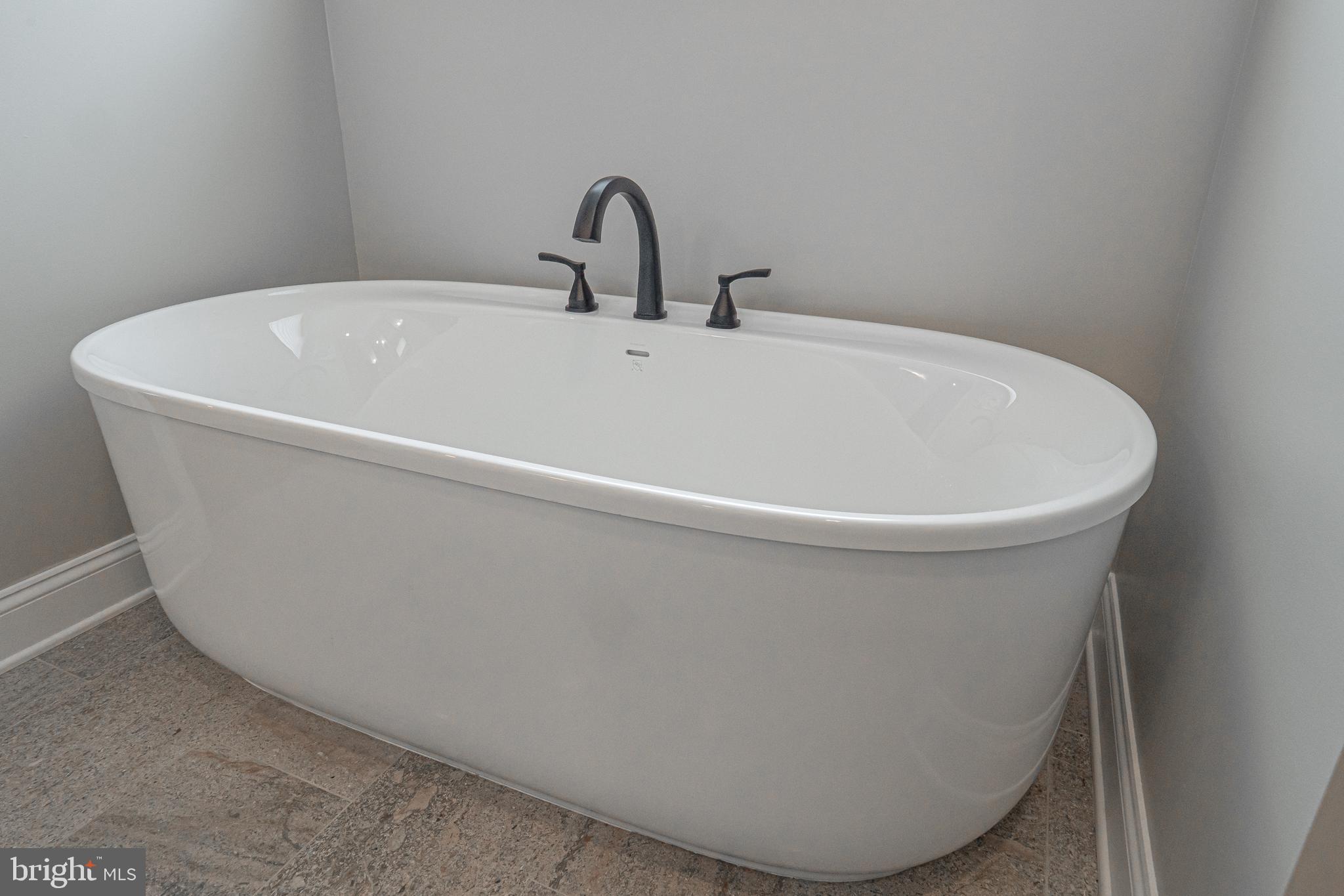 8 Timber Mill Lane, Unit TAGLIO Landenberg, PA 19350 - Photo 27 of 42 a white bath tub sitting in a bathroom