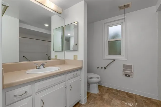a bathroom with a sink toilet and mirror