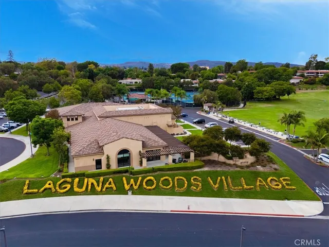 a view of a swimming pool with a garden and seating area