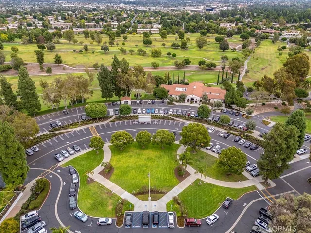 an aerial view of residential houses with outdoor space and swimming pool