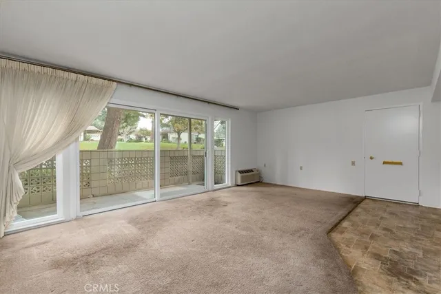 a view of an empty room with a balcony