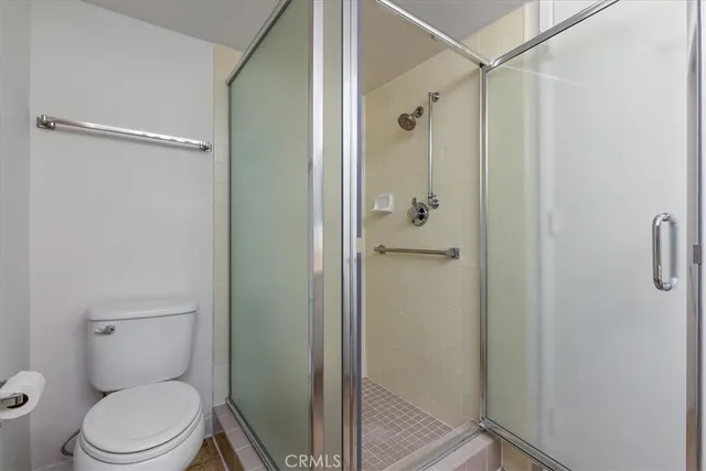 a bathroom with a toilet a sink and shower