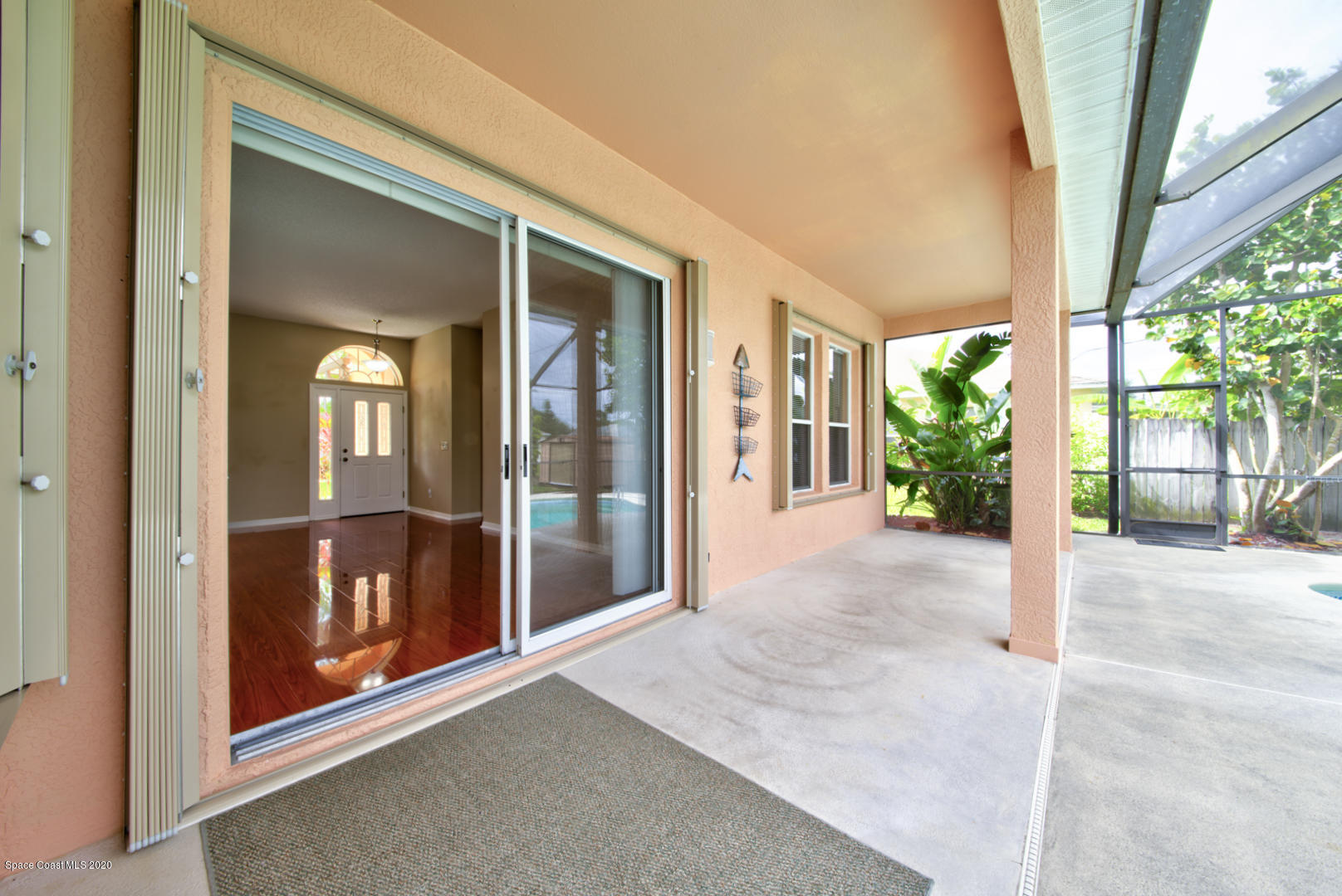 581 Raleigh Road Southeast Palm Bay, FL 32909 - Photo 14 of 60 lanai & sliders to living room