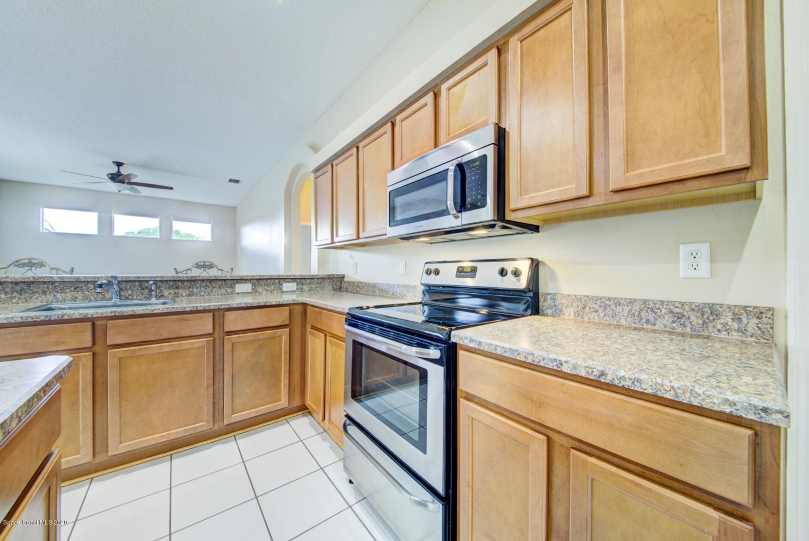 581 Raleigh Road Southeast Palm Bay, FL 32909 - Photo 32 of 60 kitchen with matching range & microwave