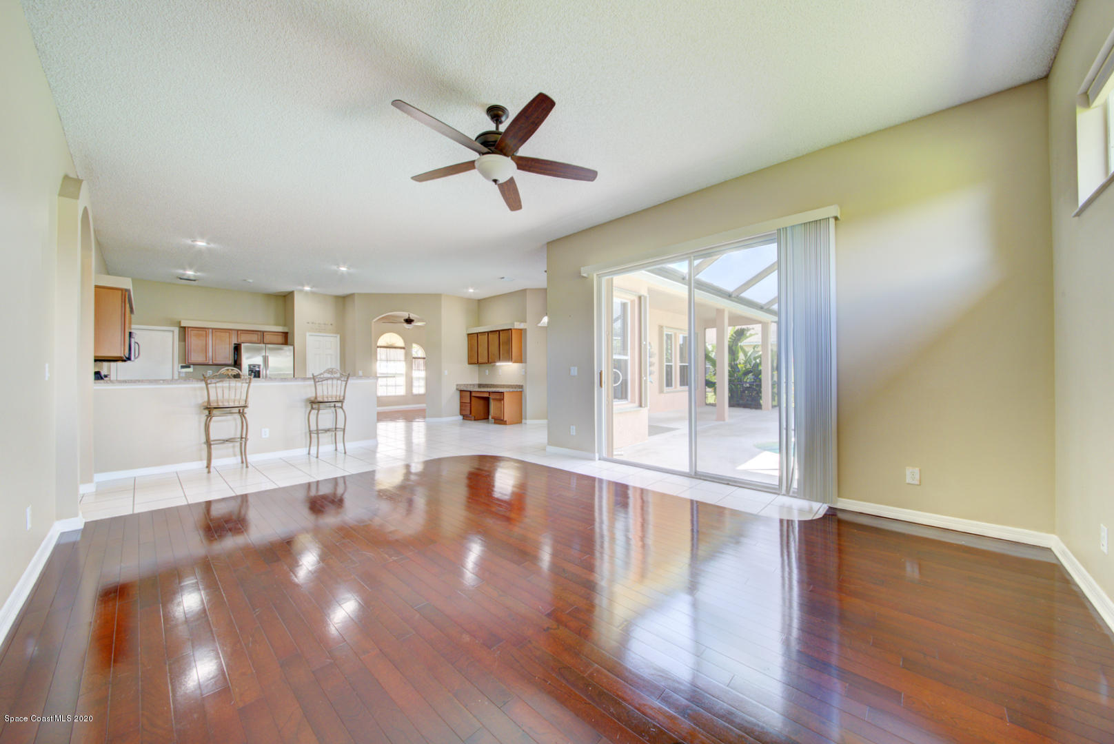 581 Raleigh Road Southeast Palm Bay, FL 32909 - Photo 40 of 60 family room with sliders to pool area