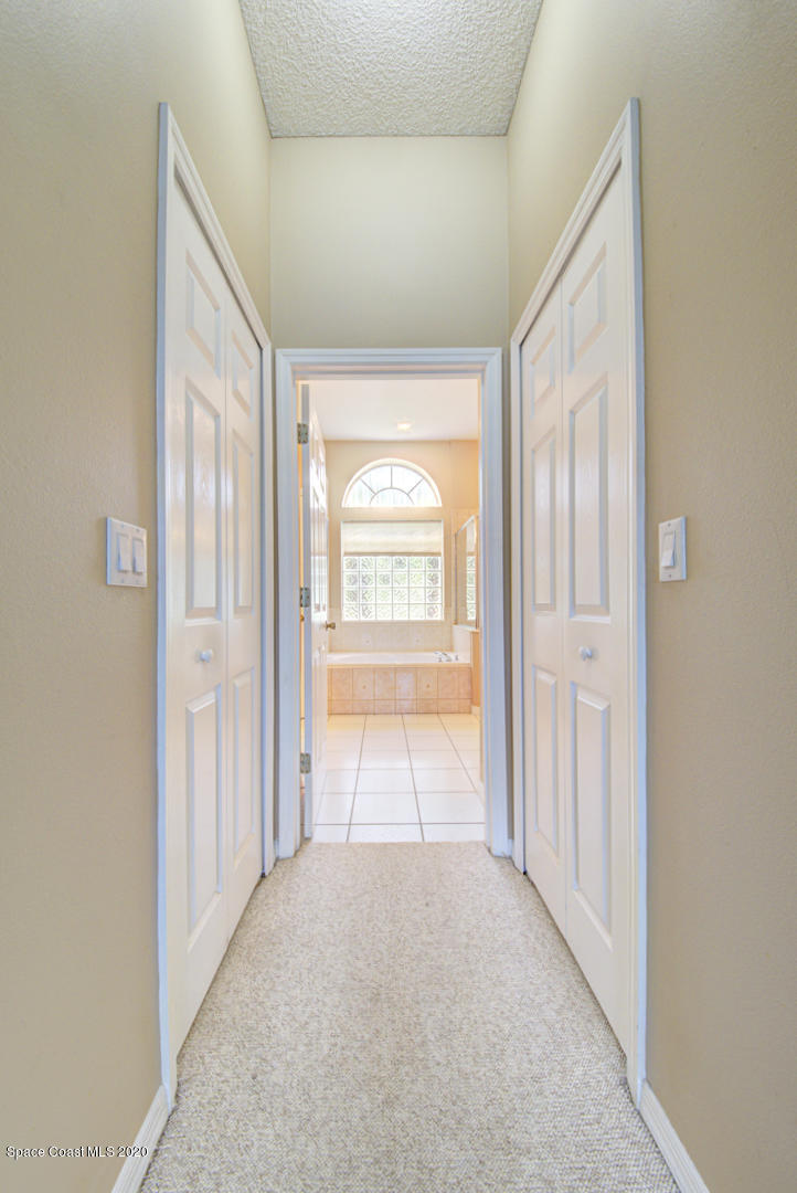 581 Raleigh Road Southeast Palm Bay, FL 32909 - Photo 49 of 60 master bedroom ensuite hall