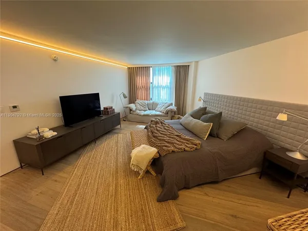 a kitchen with a sink a stove wooden floor and cabinets