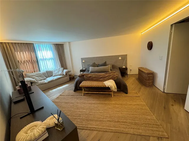 a view of a patio with a table and chairs under an umbrella