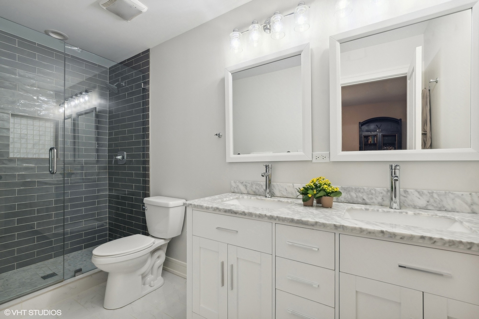 269 Riverside Drive Northfield, IL 60093 - Photo 15 of 28 a bathroom with a granite countertop toilet sink and mirror