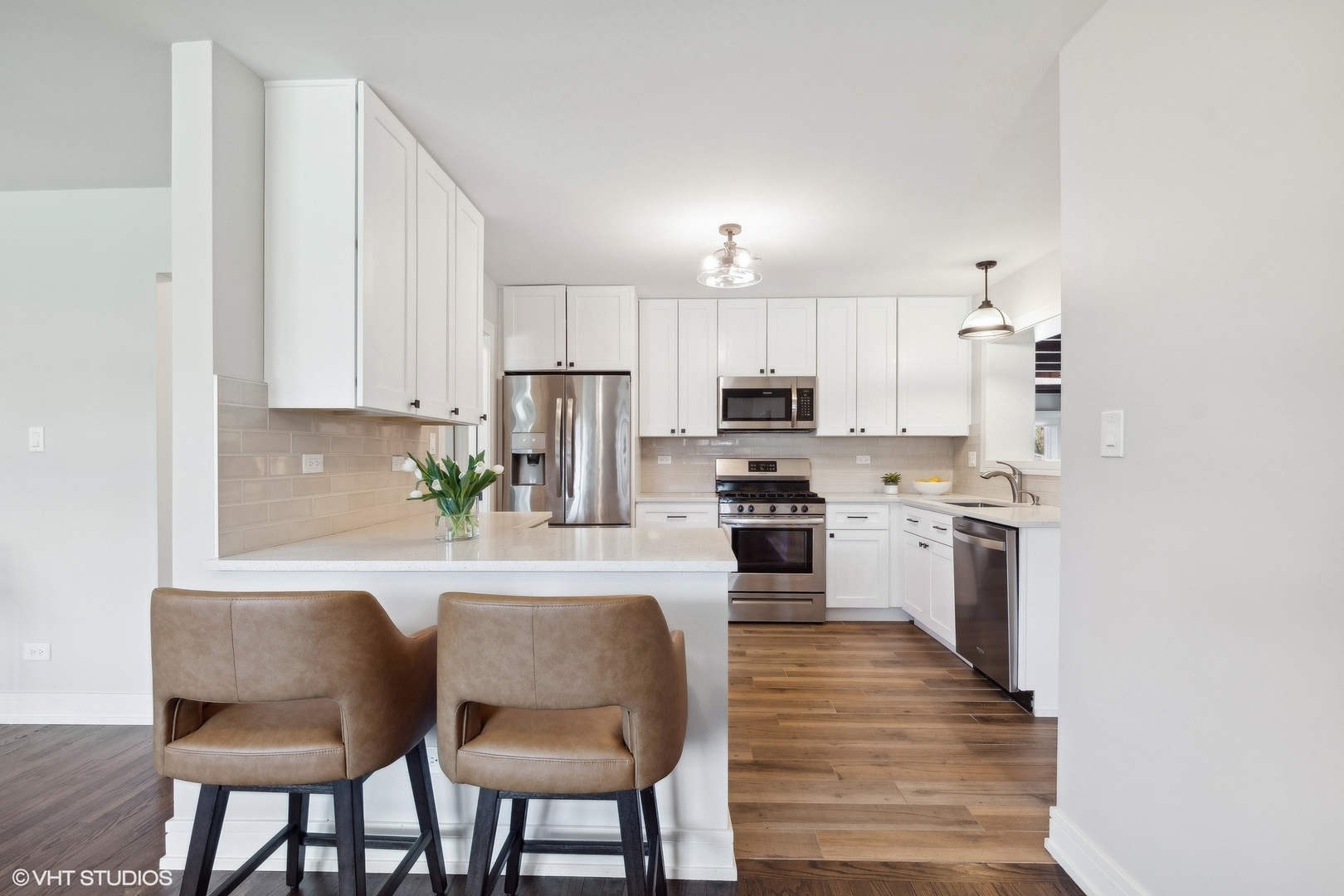 269 Riverside Drive Northfield, IL 60093 - Photo 6 of 28 a kitchen with kitchen island white cabinets and stainless steel appliances