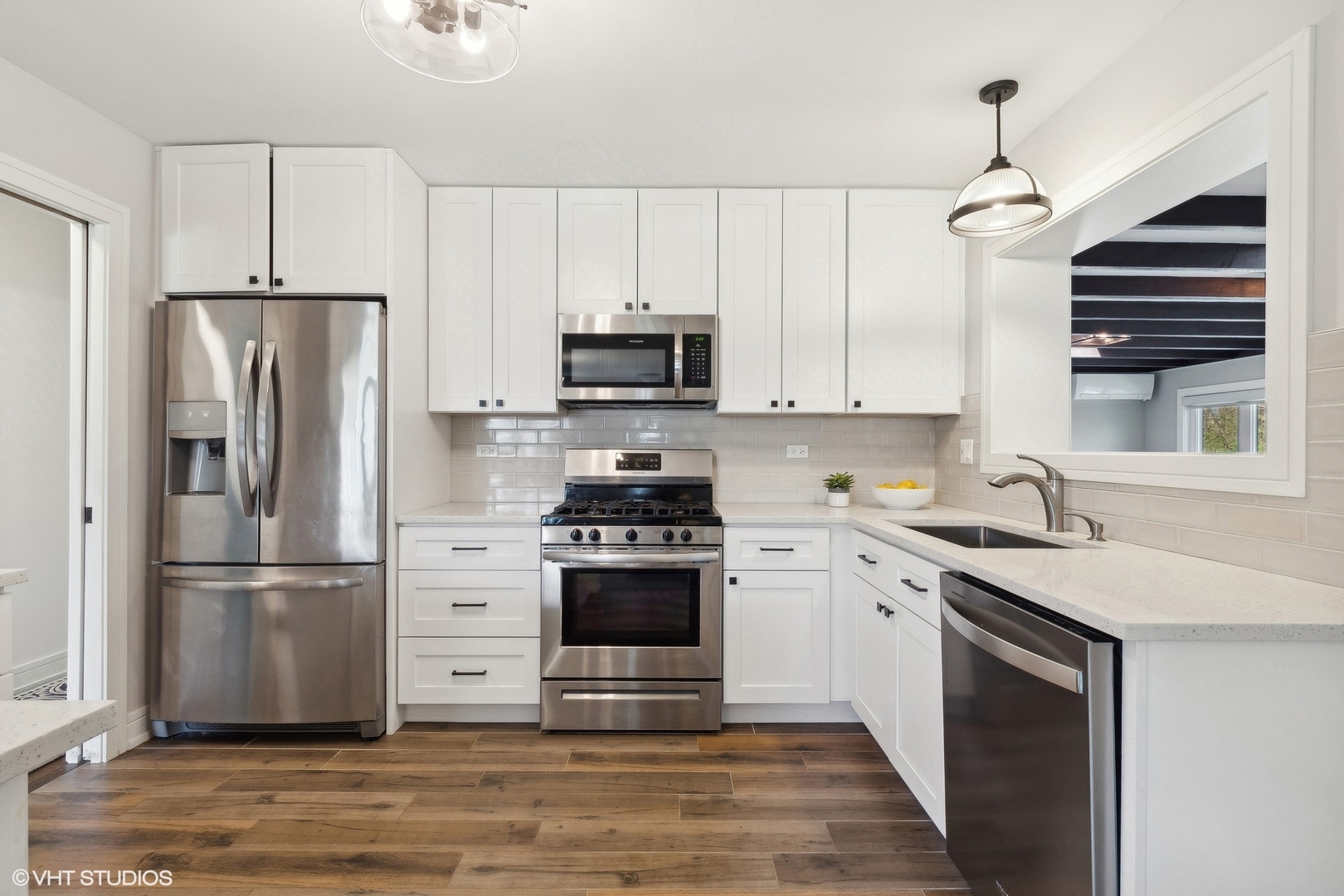 269 Riverside Drive Northfield, IL 60093 - Photo 7 of 28 a kitchen with cabinets stainless steel appliances and wooden floor