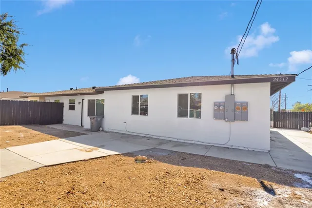 a view of a backyard with a large tree
