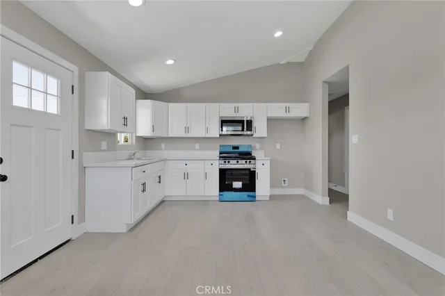 a kitchen with stainless steel appliances a refrigerator sink and stove