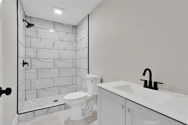 a bathroom with a toilet sink and shower
