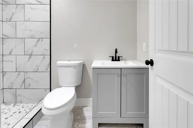 a bathroom with a sink a toilet and mirror