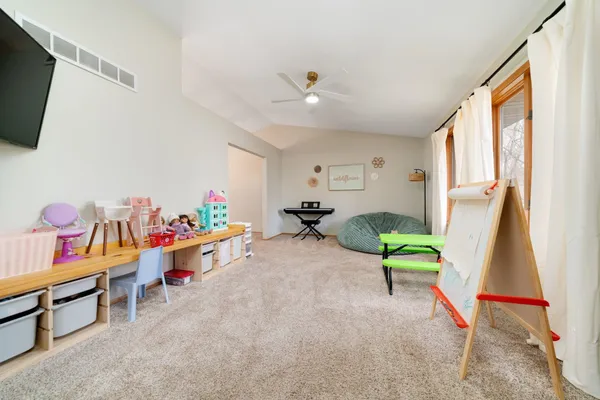 a room with furniture a flat screen tv and a window