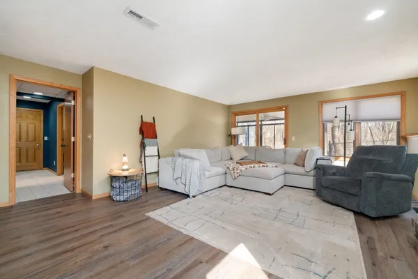 a living room with furniture and wooden floor