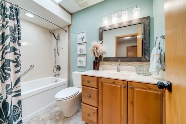 a bathroom with a sink a toilet and shower